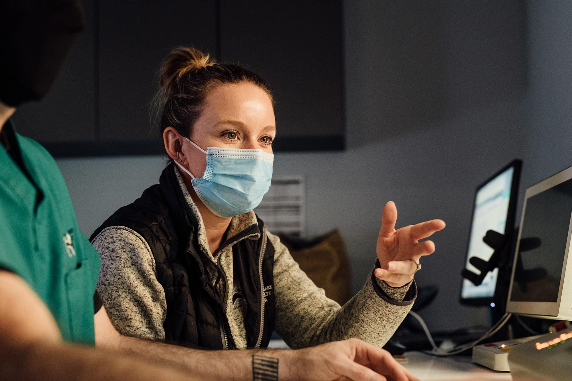 female doctor talking about results on computer screen