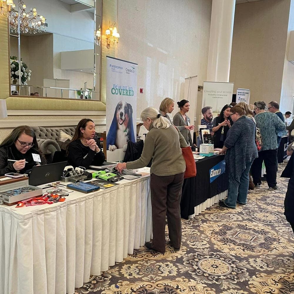 People Exploring Booths At Veterinary Education Conference