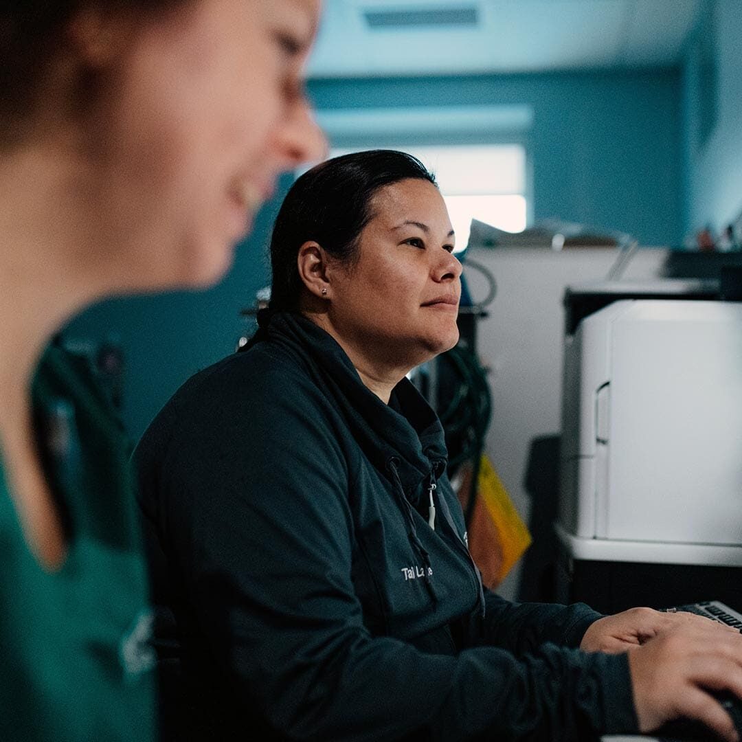 Techs Looking At Scans Of Oncology Patient